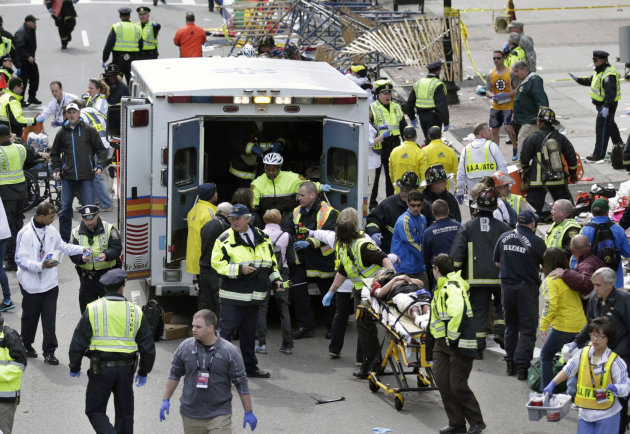 FILE - Medical workers aid injured people at the finish line of the 2013 Boston Marathon following an explosion in Boston, Monday, April 15, 2013. More than 200 were injured in the bombings and no one knows yet what the total medical costs will be. (AP Photo/Charles Krupa)