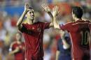 Spain player's Sergio Busquets, left, is congratulated by teammate Cesc Fabregas, right, after scoring a goal against Macedonia during a Euro 2016 Group C qualifying round soccer match, at Ciutat de Valencia stadium, in Valencia, Spain, on Monday, Sept. 8, 2014. (AP Photo/Alberto Saiz)