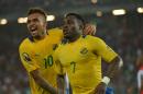 Gabon's Malick Evouna (R) celebrates with teammate Fredeic Wagha after scoring a goal during the 2015 African Cup of Nations group A football match between Burkina Faso and Gabon at Bata Stadium in Bata on January 17, 2015