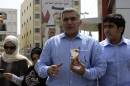 This May 28, 2011 photo, Bahraini human rights activist Nabeel Rajab, center, accompanied by his wife Sumaya, left, daughter Malak, second left, and son Adam, right, leaves a Manama, Bahrain, police station. Rajab was formally charged on Thursday, Oct. 9, 2014, with insulting the ministries of defense and interior. His court date was set for Oct. 19. Rajab was detained Oct. 1 over his tweets alleging that Bahrain's security institutions were incubators for extremist ideology. His lawyer Jalila al-Sayed said he was also accused of 