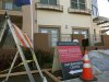 Construction equipment sits next to signs advertising new condominium homes for sale in South San Francisco