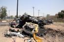 Destroyed vehicles are seen at the site of a suicide car bomber in Khalis, north of Baghdad