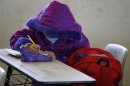 School girl wears a thick anorak to protect against low temperatures while attending class in Ciudad Juarez