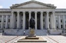 FILE - In this Monday, Aug. 8, 2011 file photo, a statue of former Treasury Secretary Albert Gallatin stands outside the Treasury Building in Washington. The Treasury reports on the federal budget deficit for May, on Wednesday, June 12, 2013. (AP Photo/Jacquelyn Martin, File)