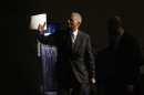 U.S. Attorney General Eric Holder gestures as he exits after speaking at the annual meeting of the American Bar Association in San Francisco