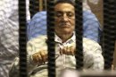 Egypt's ousted President Mubarak sits inside a dock at the police academy on the outskirts of Cairo