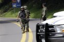 Mexican marines stand guard as U.S. officials and Mexican investigators take evidence from the scene where two CIA officers were shot on road near Tres Marias, outside Mexico City