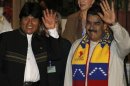Bolivia's President Evo Morales and his Venezuelan counterpart Nicolas Maduro wave during a meeting in Cochabamba