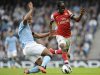 Manchester City's Kompany challenges Arsenal's Gervinho during their English Premier League soccer match in Manchester