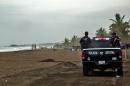 Police patrol the beach in Boca de Pascuales, Colima State, Mexico, on October 22, 2015 ahead of the arrival of fast-moving hurricane Patricia