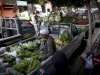 An Egyptian street vendor sits at the back of a pickup truck along with vegetables displayed for sale, in Cairo, Egypt, Thursday, Jan. 3, 2013. (AP Photo/Nasser Nasser)