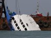 Officials check on a half submerged boat after it collided Monday night near Lamma Island, off the southwestern coast of Hong Kong Island Tuesday Oct. 2, 2012. The boat packed with revelers on a long holiday weekend collided with a ferry and sank off Hong Kong, killing at least 36 people and injuring dozens, authorities said.  (AP Photo/Vincent Yu)