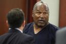 O.J. Simpson stands at the end of an evidentiary hearing in Clark County District Court on May 17, 2013 in Las Vegas