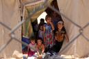 Iraqi children, whose families fled IS group jihadists in Fallujah area, at a camp for displaced people in Amriyat al-Fallujah on June 14, 2016