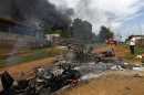 Motorcycles and houses destroyed in a fire after a riot between Muslims and Buddhist are seen in Lashio township