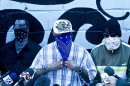 Masked members of the 18th Street gang give a press conference inside the San Pedro Sula prison in Honduras, Tuesday, May 28, 2013. Honduras' largest and most dangerous street gangs have declared a truce, offering the government peace in exchange for rehabilitation and jobs. A Mara Salvatrucha spokesman says the gang and a rival known as 18th Street will commit to zero violence and zero crime in the streets as first step show of good faith. (AP Photo/Esteban Felix)