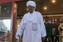 Sudanese President Omar al-Bashir walks out of a hotel in Abuja