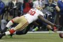 Seattle Seahawks' Russell Wilson and San Francisco 49ers' Aldon Smith go after Wilson's fumble on the first play of the first half of the NFL football NFC Championship game Sunday, Jan. 19, 2014, in Seattle. The 49ers recovered the ball. (AP Photo/Marcio Jose Sanchez)