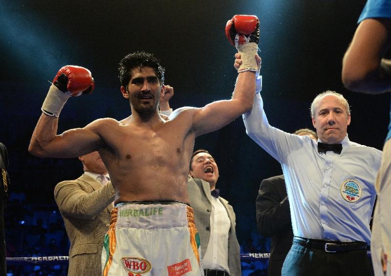 India's boxer Vijender Singh celebrates after defeating Australia's Kerry Hope for the WBO Asia Pacific Super Middleweight title in New Delhi on July 16, 2016 (AFP Photo/Prakash Singh)