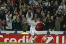 Real Madrid's Karim Benzema celebrates his goal with fans during a Group B Champions League soccer match between Real Madrid and Liverpool at the Santiago Bernabeu stadium in Madrid, Spain, Tuesday Nov. 4, 2014. (AP Photo/Paul White)