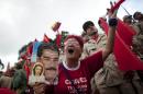 A supporter holding a picture of Venezuela's President Nicolas Maduro yells as she listens to Maduro's speech during a rally to commemorate the end of Marcos Perez Jimenez's dictatorship 57 years ago, in Caracas, Venezuela, Friday, Jan. 23, 2015. President Maduro spoke against the planned visit by the ex-presidents, Andres Pastrana of Colombia, Felipe Calderon of Mexico and Sebastian Pinera of Chile, saying that the three men are coming to Venezuela to support a right wing coup against the government. (AP Photo/Ariana Cubillos)