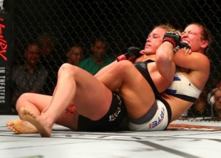  Miesha Tate applies a chokehold to win by submission against Holly Holm at UFC 196. (Reuters)