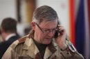 France's Chief of the Defence Staff Admiral Guillaud speaks on a mobile phone at the presidential palace in Bamako, Mali