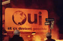 FILE - In this Monday, Oct. 30, 1995 file photo, police watch a fire burn underneath a "Oui" pro-separatist sign after federalists won the Quebec independence referendum. Quebec has always been apart from the rest of Canada by keeping French as its first tongue. (AP Photo/The Canadian Press, Tom Hanson)