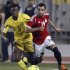 Egypt's Mohamed Salah fights for the ball with Mozambique's Martinho Mucana during their 2014 World Cup Brazil qualifying soccer match at Borg El Arab "Army Stadium"