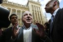 Russian oligarch Boris Berezovsky speaks to members of the media after losing his court battle against Roman Abramovich at a division of the High Court in London