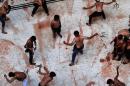 Indian Shiite Muslims men flagellate themselves in a local mosque at the end of a Ashura procession in New Delhi, on November 4, 2014