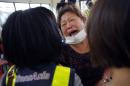A relative of a victim in the TransAsia Airways flight GE222 crash cries during a funeral service on the Taiwan island of Penghu, Friday, July 25, 2014. Stormy weather on the trailing edge of Typhoon Matmo was the likely cause of the plane crash that killed more than 40 people, the airline said Thursday. (AP Photo/Wally Santana)
