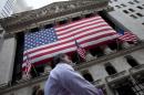 FILE - In this Monday, Aug. 8, 2011, file photo, a pedestrian walks past the New York Stock Exchange in New York. U.S. stocks were mostly unchanged Friday, March 27, 2015, after four straight days of losses. (AP Photo/Jin Lee, File)