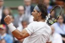 Nadal of Spain celebrates beating Brands of Germany in their men's singles match at the French Open tennis tournament in Paris