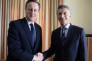 In this handout picture released by the Office of the President of Argentina, President Mauricio Macri, right, shakes hands with British Prime Minister David Cameron, during a meeting of the World Economic Forum in Davos, Switzerland, Thursday, Jan. 21, 2016. (The Office of the President of Argentina Photo via AP)