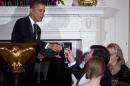 President Barack Obama toasts after delivering remarks during a dinner for the National Governors Association in the State Dining room of the White House on Sunday, Feb. 23, 2014, in Washington. (AP Photo/ Evan Vucci)