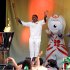 In this photo provided by LOCOG, torchbearer 153 Daley Thompson acknowledges the crowd after lighting the cauldron at the end of Day 68 in the Torch Relay on Wednesday July 25, 2012, in London. (AP Photo/LOCOG, Yui Mok)