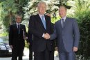Russia's President Putin shakes hands with Italy's Prime Minister Monti at the Bocharov Ruchei state residence in Sochi