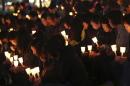 People take part in a candlelight vigil for missing passenger onboard the South Korean ferry Sewol, which capsized on last Wednesday, in Ansan