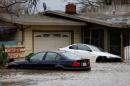 A partially submerged home and vehicles are seen during a winter storm in Petaluma
