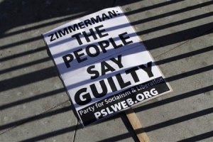 A sign lays on the ground at a protest of the acquittal 