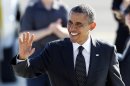 President Barack Obama waves to supporters on his arrival at Boeing Field Tuesday, July 24, 2012, in Seattle. Obama is scheduled to attend a pair of campaign fund-raisers in the area. (AP Photo/Elaine Thompson)