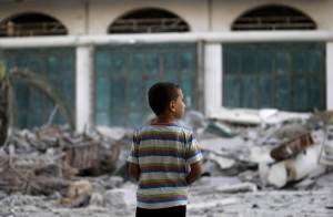 A Palestinian boy inspects the destruction in his neighborhood &hellip;