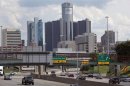 Vehicles enter and exit downtown on freeway, in front of General Motors World Headquarters in downtown Detroit