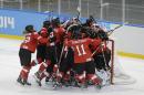 Team Switzerland celebrates their 2-0 victory over Russia during the 2014 Winter Olympics women's ice hockey quarterfinal game at Shayba Arena, Saturday, Feb. 15, 2014, in Sochi, Russia. (AP Photo/Matt Slocum)