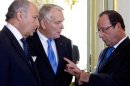 France's President Hollande speaks with French Foreign Minister Fabius and Prime Minister Ayrault before a National Security Council meeting at the Elysee Palace in Paris