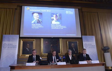 Pictures of the 2012 Nobel Prize for Physics laureates Serge Haroche (L) of France and David Wineland of the U.S. are displayed on a screen during a news conference at the Royal Swedish Academy of Science in Stockholm, October 9, 2012. REUTERS/Bertil Enevag Ericson/Scanpix