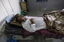 A patient suffering from cholera rests inside a hospital in Baghdad
