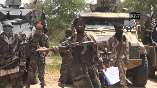 A screengrab taken on July 13, 2014 from a video released by the Nigerian Islamist extremist group Boko Haram shows the leader of the group, Abubakar Shekau (C)