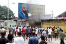 Congolese opposition supporters chant slogans as they destroy the billboard of President Joseph Kabila during a march to press the President to step down in the DRC's capital Kinshasa